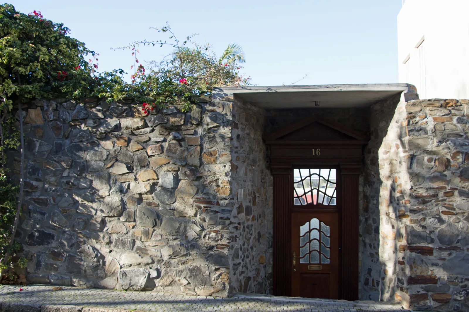A wooden door set into an old stone wall in De Waterkant